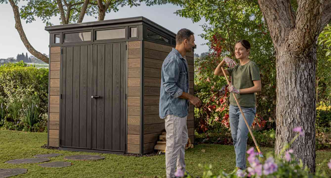 Keter money saving tips banner showing a man talking to woman who is tidying up a garden. A keter shed can be seen in the background
