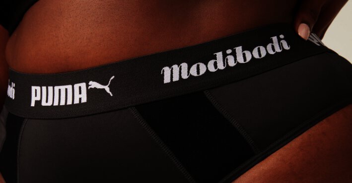 Banner der Modibodi Gutscheinseite mit Foto von Puma X Modibodi Periodenslip
