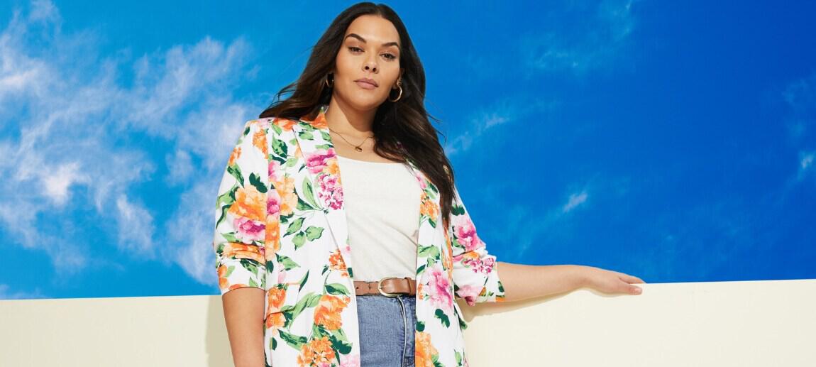 Autograph deals page image showing a woman wearing vibrant clothing leaning on a wall in front of a blue sky
