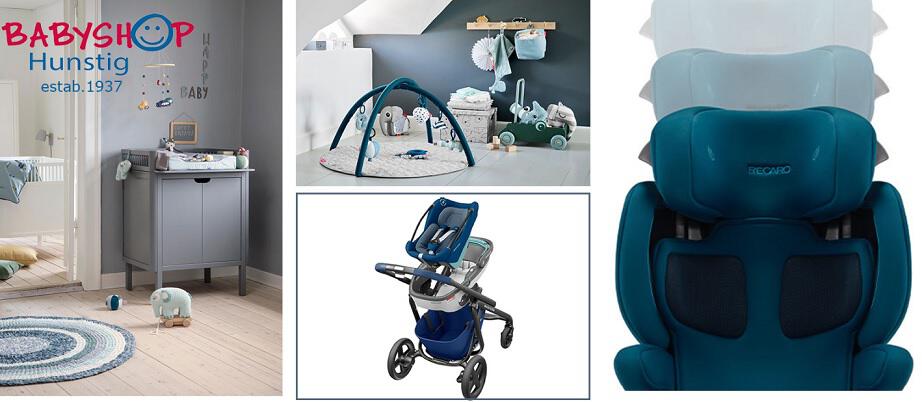 Eine in blau und grau gehaltene Babyshop Auswahl an Babymöbeln und Kinderwagen mit dem Hinweis, dass es Babyshop bereits seit 1937 gibt