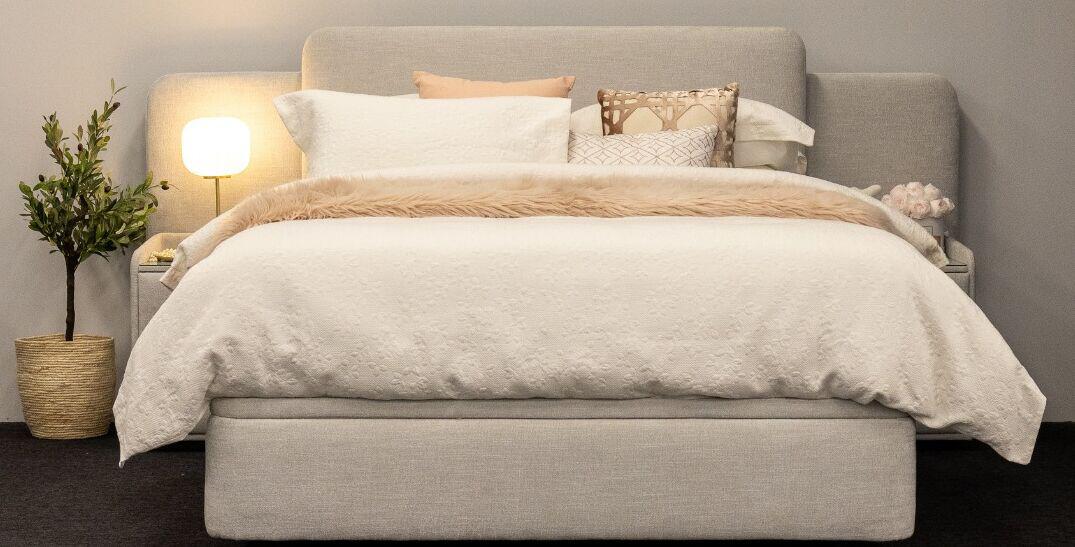 Beds N Dreams deals page banner showing a cream and grey bed within a bedroom setting
