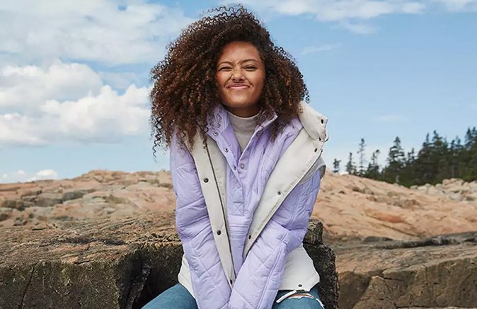 Woman wearing sweater and vest