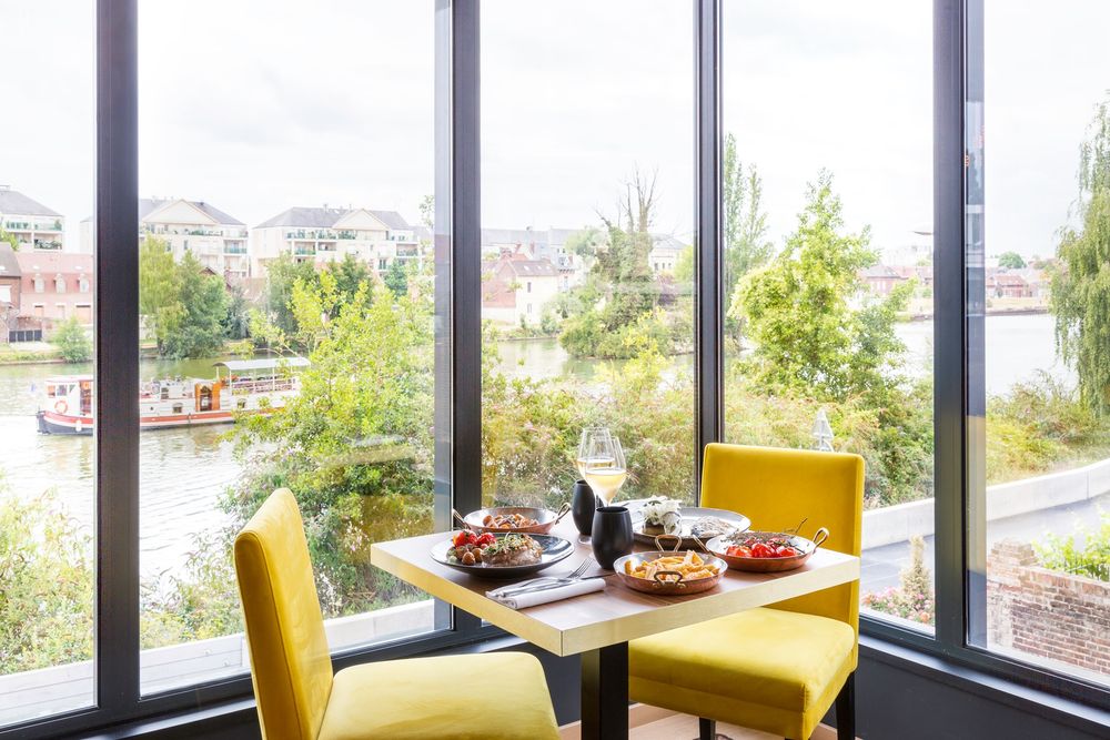 Table de petit déjeuner devant une baie vitrée