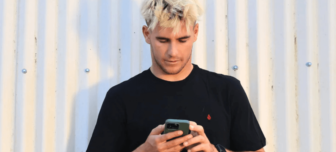 Boost Mobile ways to save banner. Image shows a man with blonde hair looking at his smartphone