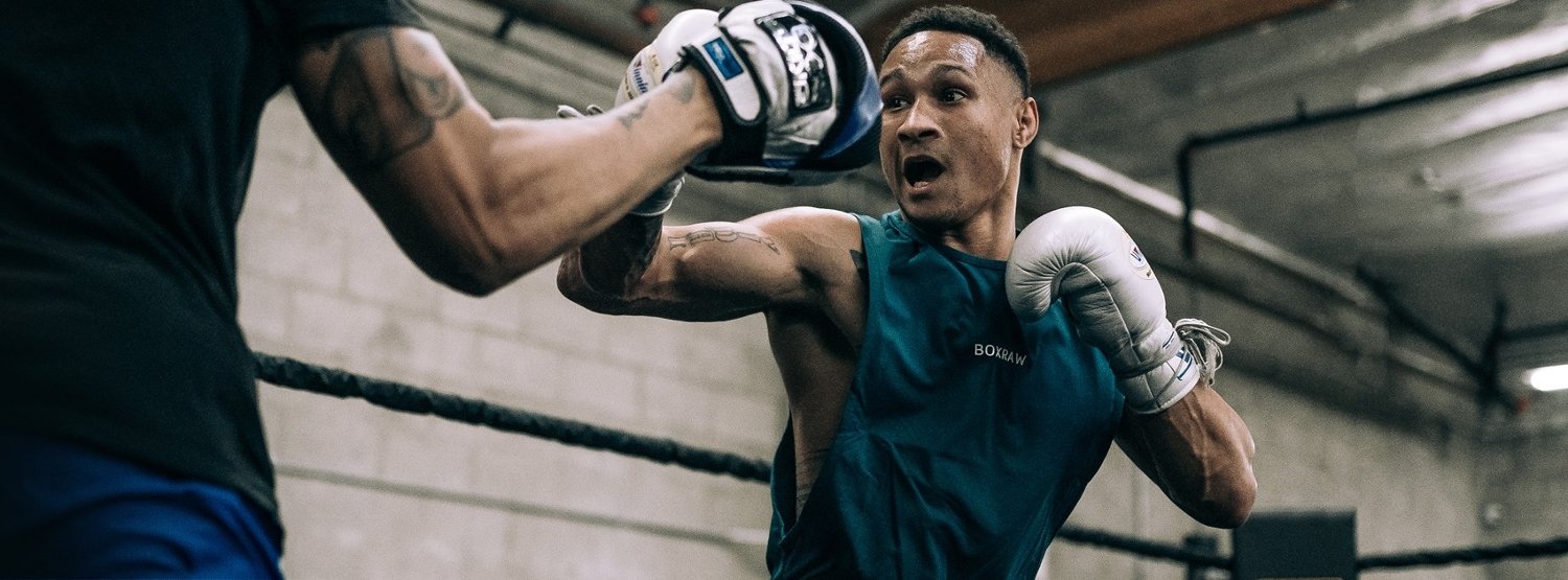 Boxer wearing BOXRAW clothing and boxing gloves