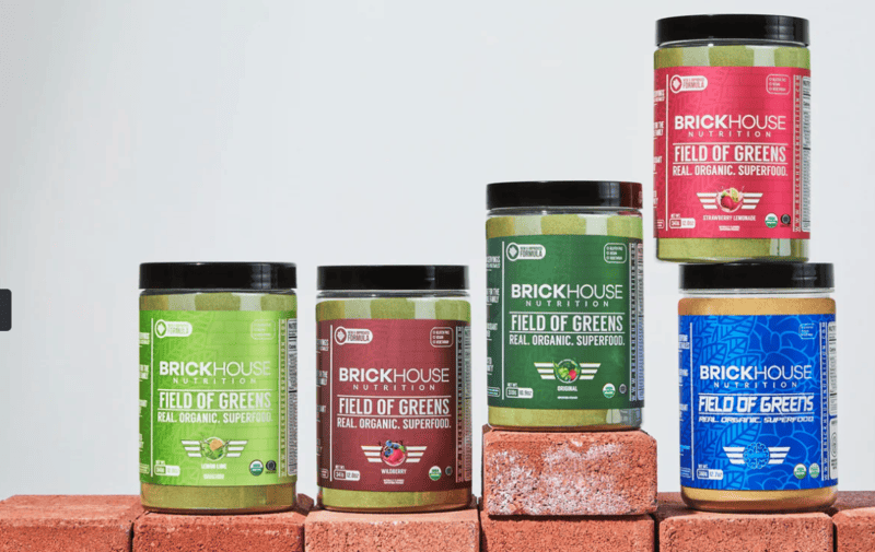 jars stacked on a brick wall