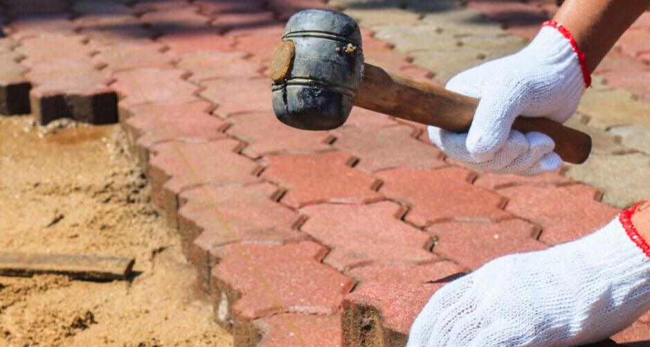Brisks diy image showing a close up of someone laying paving