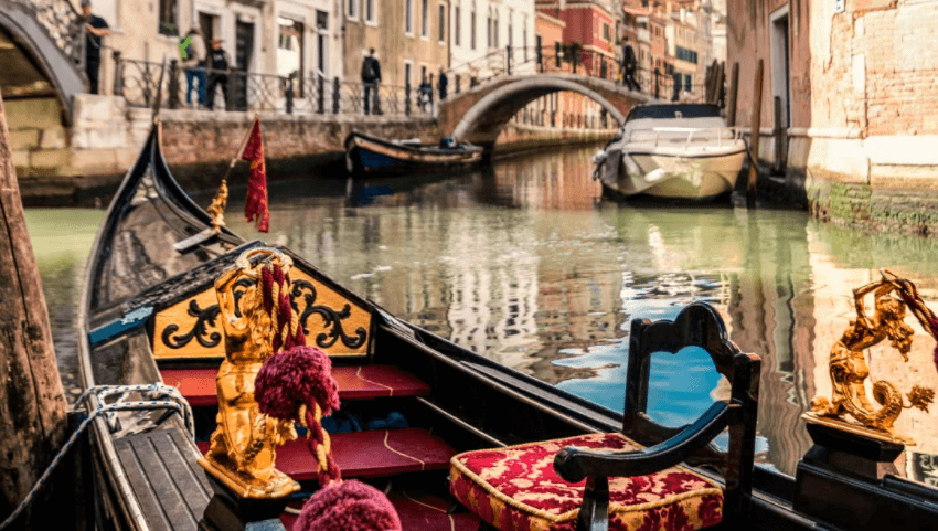 British Airways holiday photo of a Venice canal and gondola. Romantic getaway in Venice, Italy.