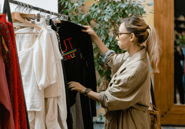 woman looking at clothes in shop
