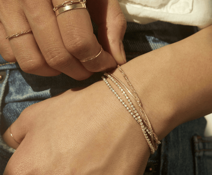 hands wearing bracelets and rings