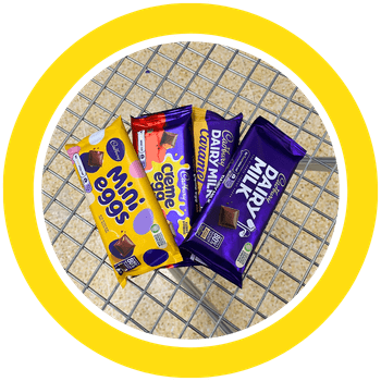 A selection of big chocolate bars in a metal shopping basket