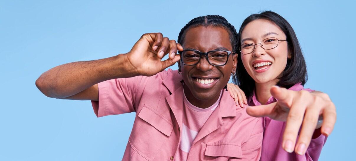 Clearly more ways to save banner featuring a man and woman wearing pink clothing and black rim glasses