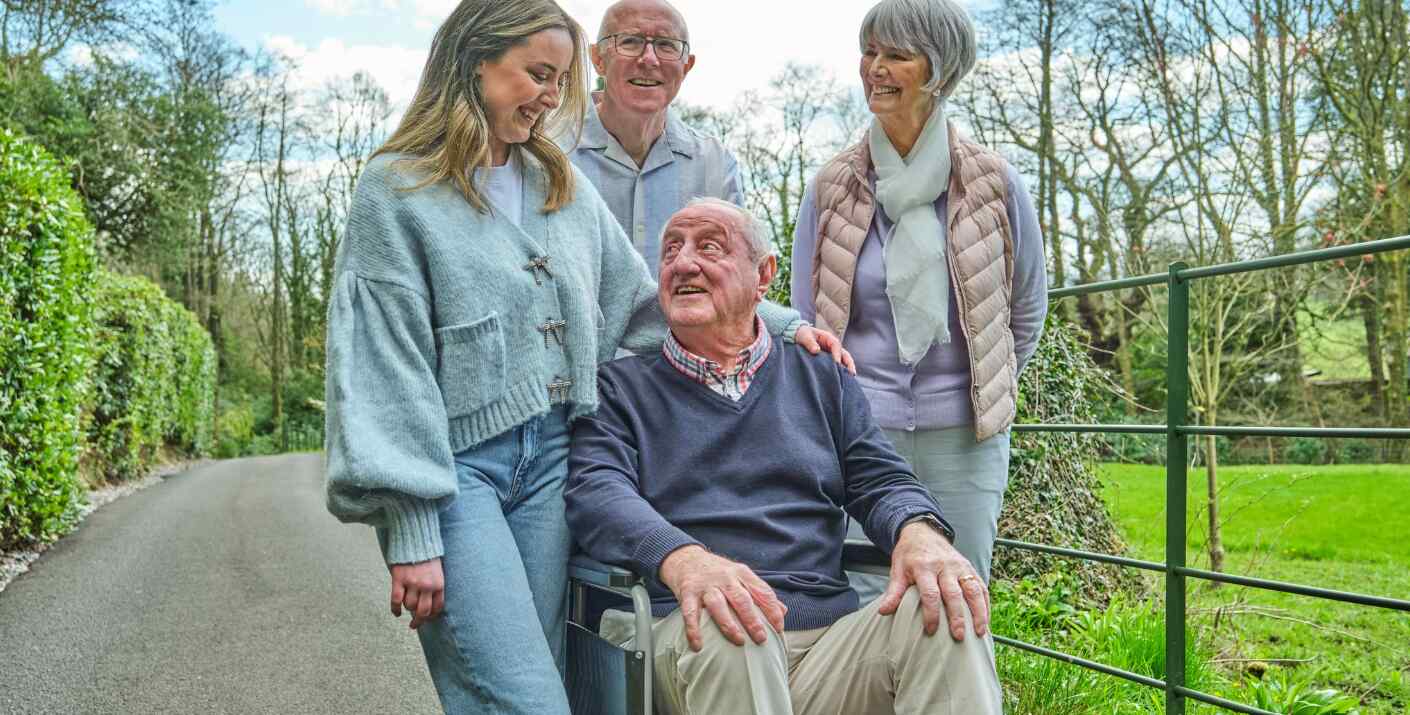 Complete Care Shop offers page image showing an elderly man in a wheelchair being pushed through a park by his smiling family