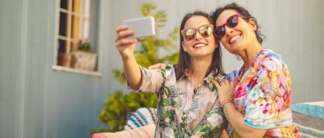 Coopers of Stortford – Two women taking a selfie in garden