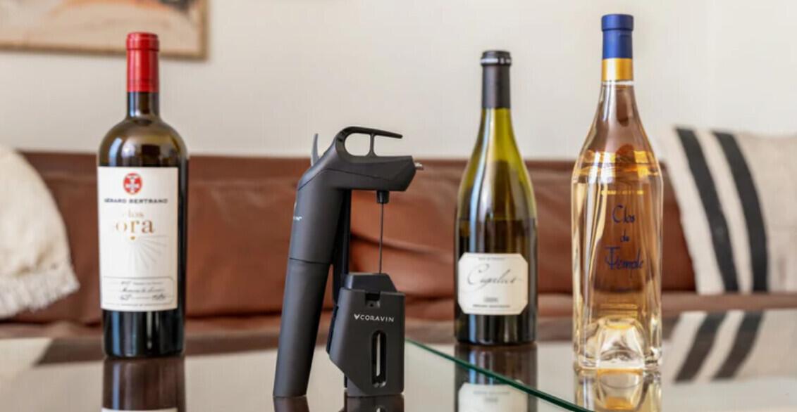 Coravin ways to save image - Three bottles of wine next to the Coravin device on a table