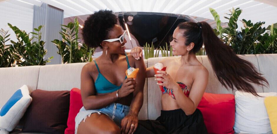 Cruise Nation deals page banner showing 2 happy women enjoying ice creams on a cruise ship
