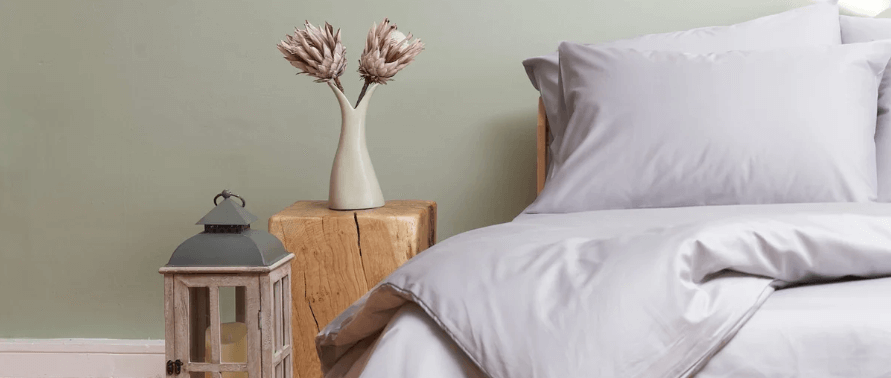 Cuddledown ways to save banner featuring a bed with grey bedding within a room set-up