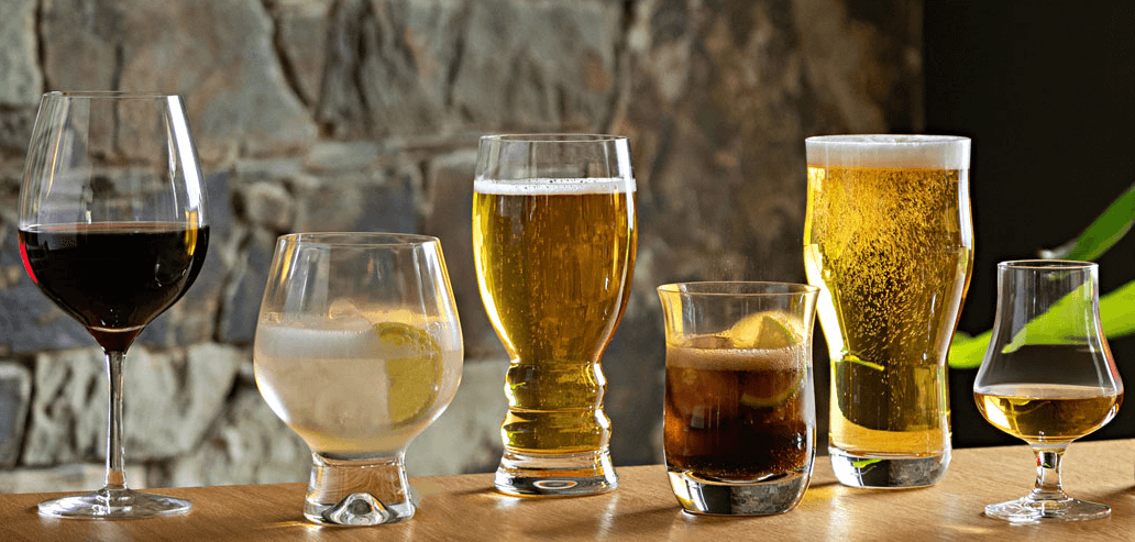 Dartington Crystal ways to save image - 6 different shaped drinking glasses in row containing various beverages
