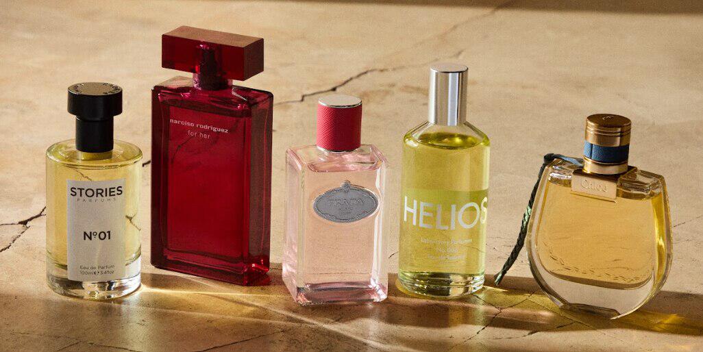 Debenhams fragrances image showing five branded perfume bottles on a marble surface
