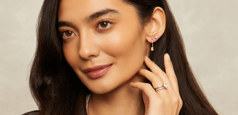 Diamonds Factory discounts banner featuring a headshot of a woman with her hand held towards her ear showcasing a ring and earrings