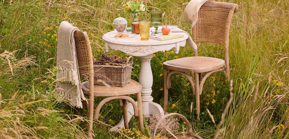 Dibor savings page banner showing a table and chairs in a field with long grass