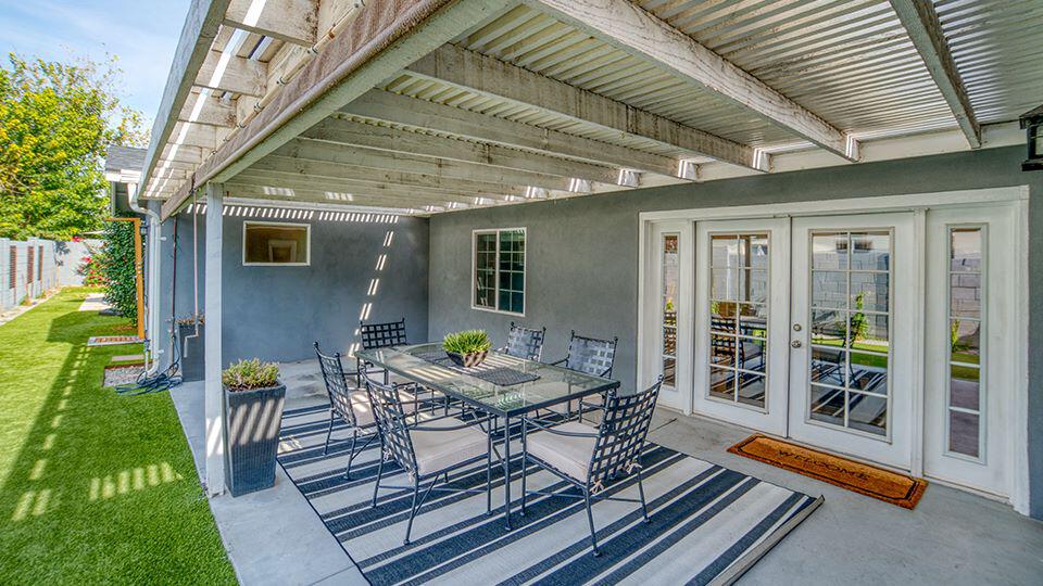 Blue and white striped outdoor rug under outdoor table on patio