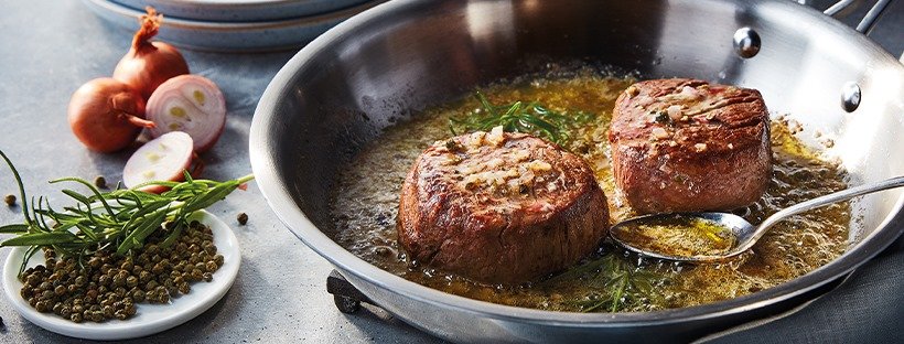 Donald Russell banner - meat, onions, herbs in cooking pan