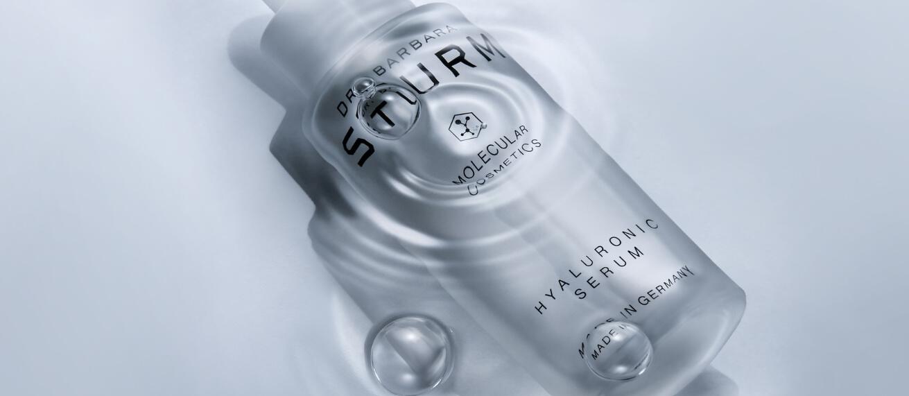 Dr. Barbara Sturm savings guide image showing a branded Hyaluronic serum bottle creating ripples in water