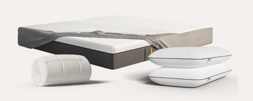 Emma deals page image featuring a mattress, duvet, and two pillows on a pale background