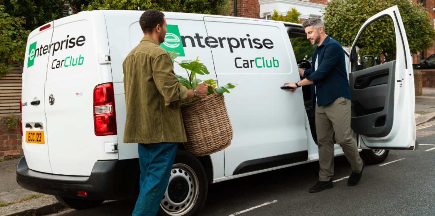 Enterprise Car Club deals image - A driver opening a branded white van side door for a man carrying a large house plant