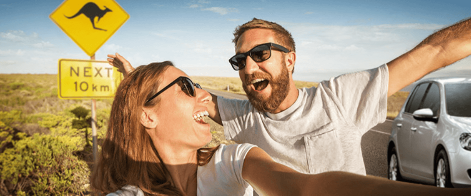 Europcar more ways to save banner. Image features a man and a woman taking a selfie in front of a kangeroo warning sign at the side of a highway