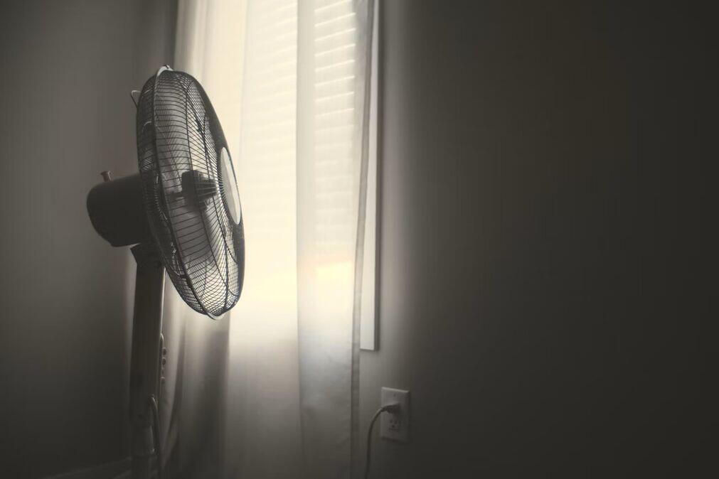 Fan in front of bedroom window to keep cool at night