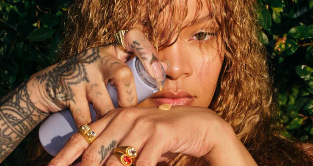 Fenty Beauty savings guide image - Close up picture of woman adding concelear to her wrist from a bottle