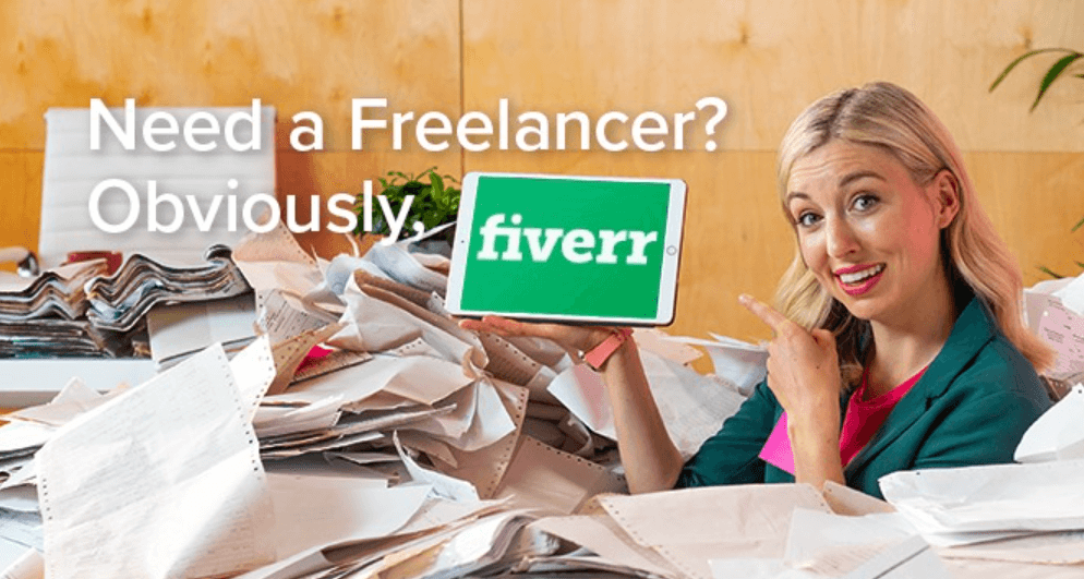 Fiverr deals page image showing a woman surrounded by paper work pointing to tablet with the company logo on the screen