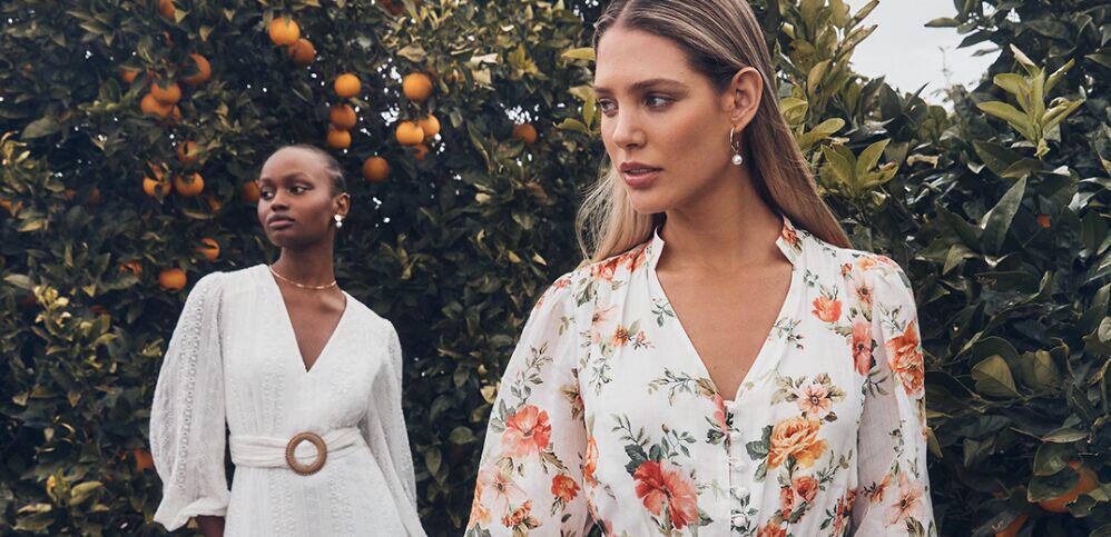 Forever New ways to save banner - 2 women in white clothing standing in front of an orange tree