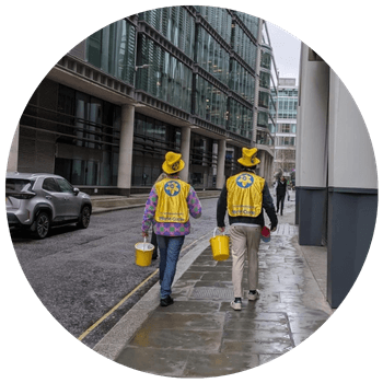 A picture of fundraisers for Marie Curie wearing yellow walking down a street