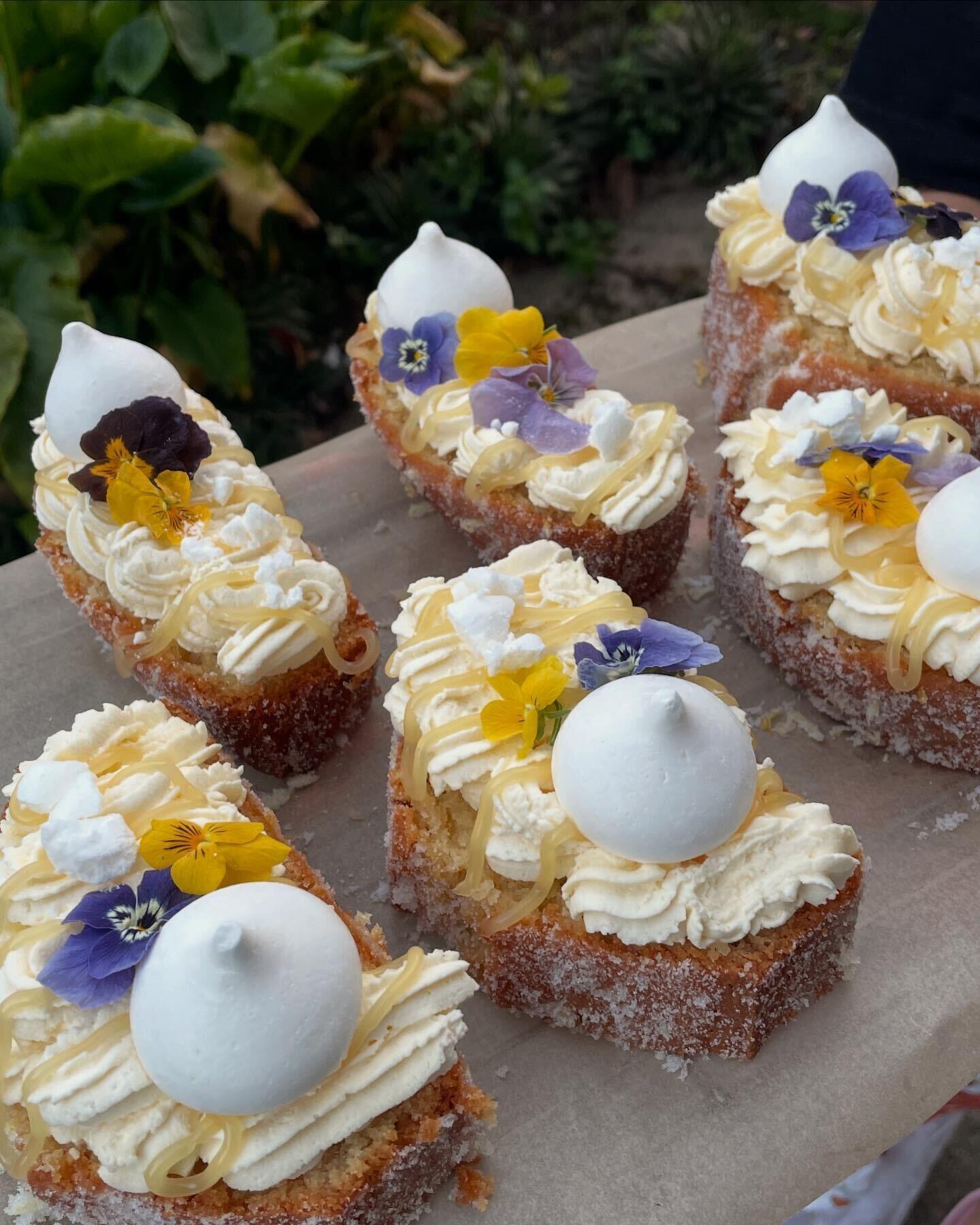 Lemon curd cake slices decorated with flowers and meringue