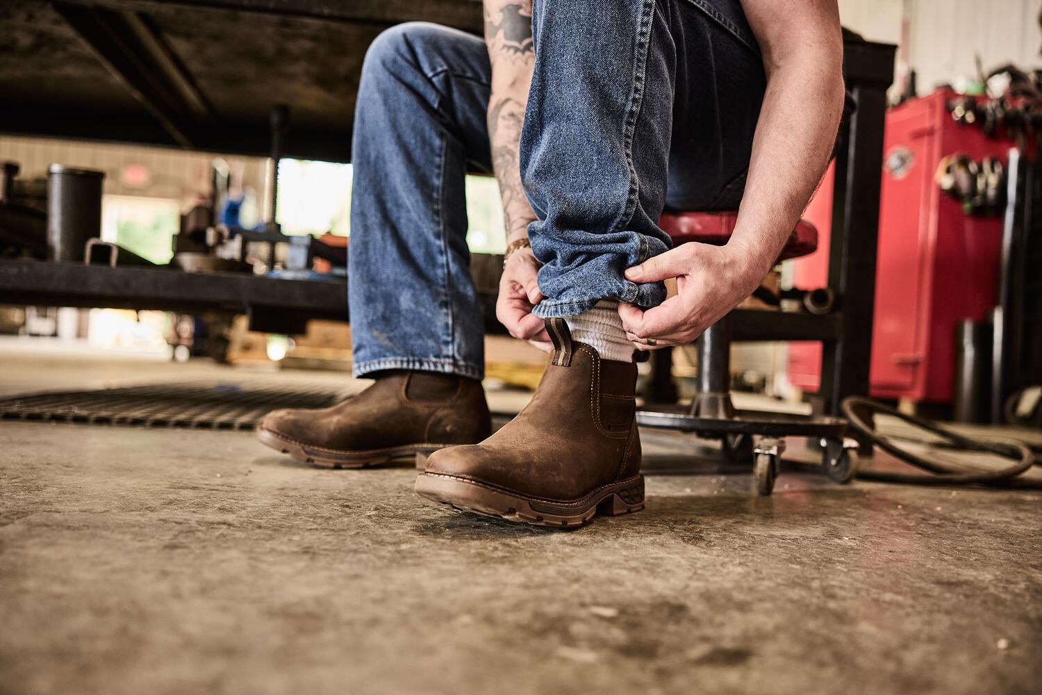 Man putting on a pair of boots from Georgia Boot