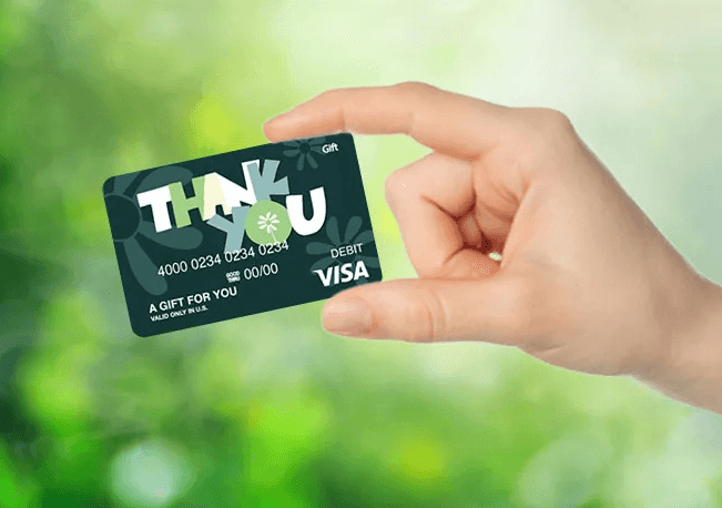 Hand holding Giftcards.com Visa gift card
