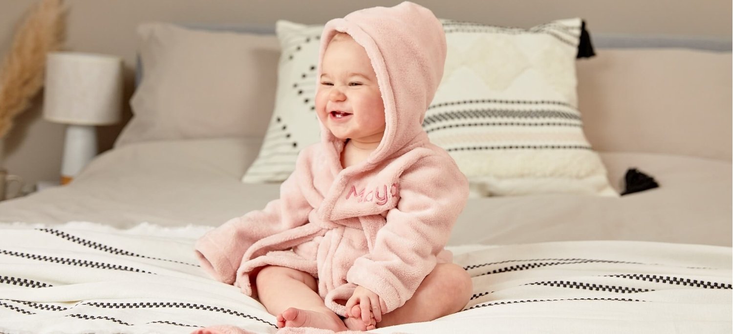 Baby wearing a customised baby robe from My 1st Years personalised gifts