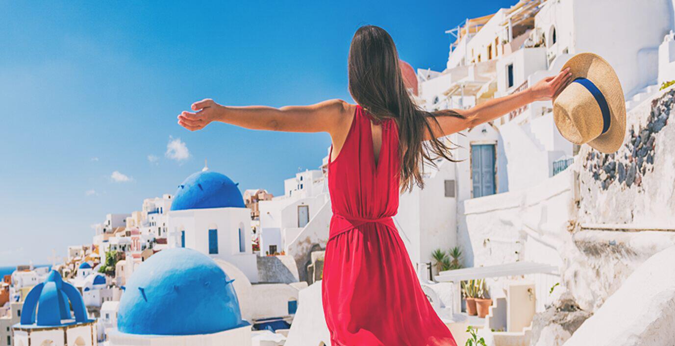 Gotogate offers page image featuring a woman in a red dress holding out her hands in front of a scenic view