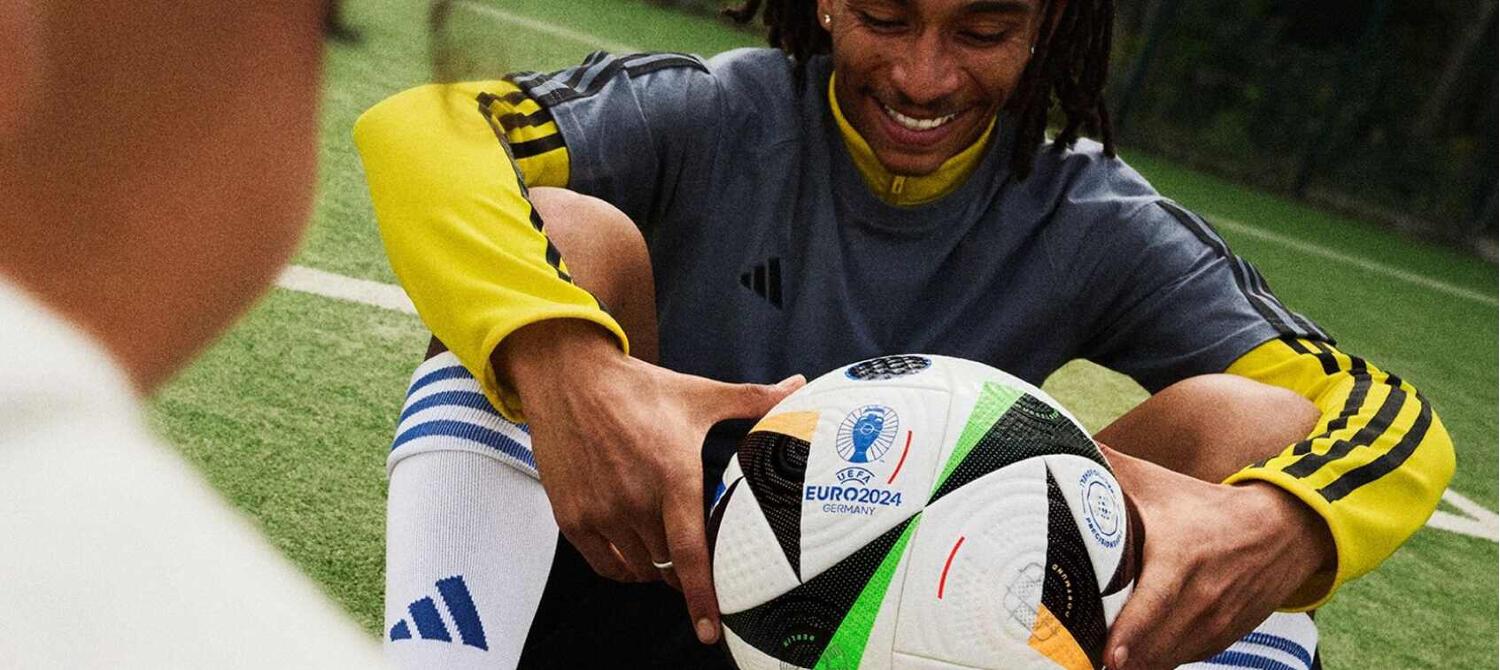 Greaves Sports ways to save banner. Image features a man in sports kit sitting and holding a football