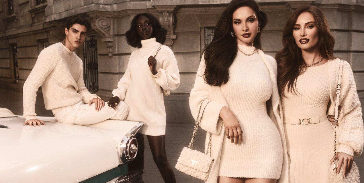Guess deals page banner - 3 women and a man wearing cream coloured clothing beside a cream vintage car