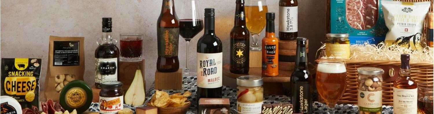 Hampers.com gift hamper banner featuring: Malbec, gin, tea, cakes, crisps, clotted cream and more