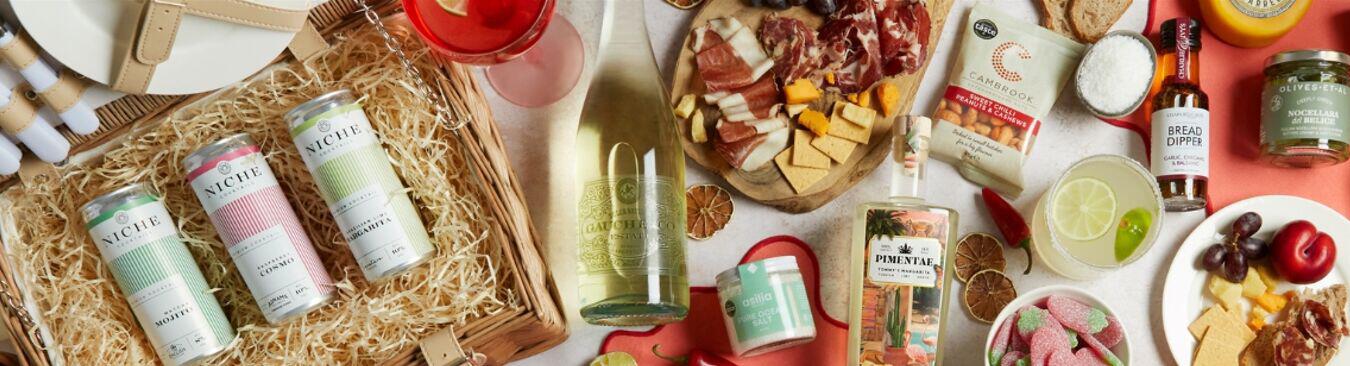 Hampers.com summer hamper banner featuring a selection of food and drink