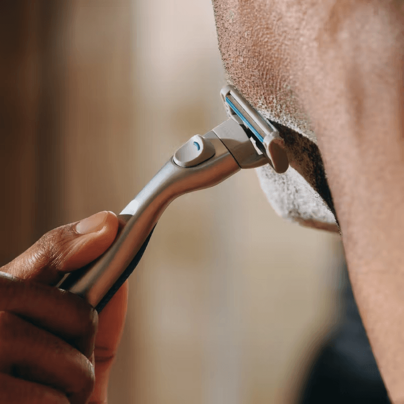 Man using Harry&apos;s razor to shave facial hair