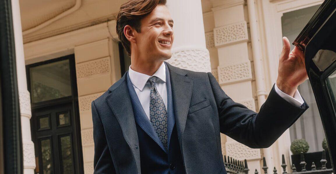 Hawes & Curtis deals page image showing a sming suited man stading outside of a taxi