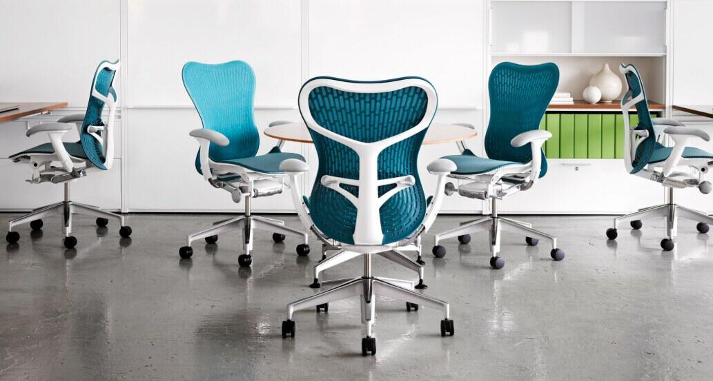 Herman Miller savings guide image featuring 5 teal and white office chairs in a professional location