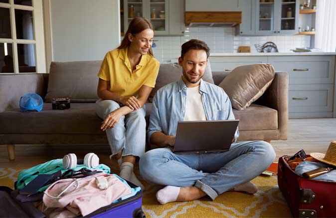 Guy and girl looking a laptop