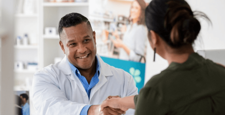 How to get a Vision Pharmacy discount banner. Image shows a woman shaking hands with a male pharmacist